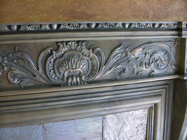 A copper faux finish makes this composition ornament fireplace show weight and texture giving this room a beautiful, strong venetian flare.